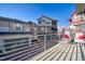 Balcony with views, patio furniture and metal railings overlooking the driveway and garages at 5295 Andes St, Denver, CO 80249