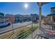 View from balcony overlooking neighborhood street with houses and cars in a suburban community under a bright sky at 5295 Andes St, Denver, CO 80249