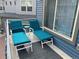 Cozy balcony featuring two cushioned lounge chairs and a small side table at 5295 Andes St, Denver, CO 80249