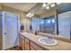 Bathroom featuring double sinks, a large mirror, vanity and a walk-in shower at 5295 Andes St, Denver, CO 80249
