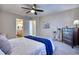 Bedroom featuring a large bed, ceiling fan, a dresser and an ensuite bathroom at 5295 Andes St, Denver, CO 80249