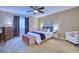 Bedroom with carpet, ceiling fan, large window, and stylish furnishings at 5295 Andes St, Denver, CO 80249