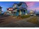 Charming two-story home featuring a well-manicured yard, brick driveway, and inviting front porch in a suburban neighborhood at 5295 Andes St, Denver, CO 80249
