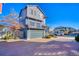 Contemporary two-story house with a two-car garage, complemented by a brick driveway and well-kept landscaping at 5295 Andes St, Denver, CO 80249