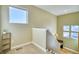 Hallway with carpet, stairs, and multiple windows, providing ample natural light at 5295 Andes St, Denver, CO 80249
