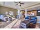 Spacious living room with hardwood floors, ceiling fan, and views into the kitchen at 5295 Andes St, Denver, CO 80249
