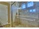 Tiled shower enclosure with glass door, and tiled floor and wall with shower head at 5295 Andes St, Denver, CO 80249