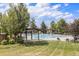 Outdoor community pool with lounge chairs, shaded areas, and lush landscaping, perfect for relaxation at 1378 S Duquesne Ct, Aurora, CO 80018