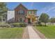 Charming two-story home with a well-manicured lawn, inviting curb appeal, and a welcoming front porch at 1378 S Duquesne Ct, Aurora, CO 80018