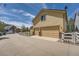 Home exterior showcasing a three-car garage, long driveway, and well-maintained landscaping at 1378 S Duquesne Ct, Aurora, CO 80018