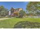 Lovely two-story home featuring a green lawn, white picket fence, and a charming, inviting facade at 1378 S Duquesne Ct, Aurora, CO 80018