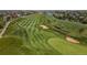 Scenic aerial view of the golf course, with green fairways, water features, and surrounding residential areas at 1378 S Duquesne Ct, Aurora, CO 80018