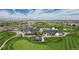 Aerial view of the golf course clubhouse and surrounding community on a bright, sunny day at 1378 S Duquesne Ct, Aurora, CO 80018