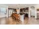 Stylish kitchen with a center island, dark cabinetry, and stainless steel appliances, perfect for cooking at 1378 S Duquesne Ct, Aurora, CO 80018