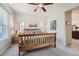 This spacious main bedroom has natural light, a ceiling fan, and leads to the main bathroom at 1378 S Duquesne Ct, Aurora, CO 80018