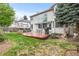 Serene backyard featuring a patio, lush lawn, mature trees, and outdoor seating area perfect for entertaining at 5146 S Argonne St, Centennial, CO 80015