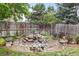 Backyard features a rock water feature, landscaping, mature trees, and decorative statues at 5146 S Argonne St, Centennial, CO 80015