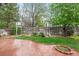 Tranquil backyard showcases a stamped concrete patio, mature trees, green grass, and a decorative arbor with seating at 5146 S Argonne St, Centennial, CO 80015