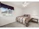 Bedroom features neutral carpet, a queen-sized bed, and a window with custom valance at 5146 S Argonne St, Centennial, CO 80015