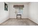 Bright, carpeted bedroom with neutral walls and a large window offering natural light at 5146 S Argonne St, Centennial, CO 80015