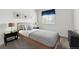 Bedroom showcases a neatly made bed with neutral tones and a classic nightstand arrangement, complete with accent lamps at 5146 S Argonne St, Centennial, CO 80015
