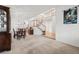 Spacious dining room area with a view of the staircase, foyer, and kitchen at 5146 S Argonne St, Centennial, CO 80015