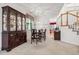 Elegant dining room with a wood china cabinet, carpet, and views of the staircase at 5146 S Argonne St, Centennial, CO 80015