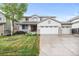 Charming two-story home with a three-car garage, covered porch, manicured lawn, and mature trees at 5146 S Argonne St, Centennial, CO 80015