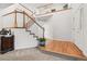 Inviting foyer features a staircase with wood and white trim, carpeted steps, and hardwood flooring at 5146 S Argonne St, Centennial, CO 80015
