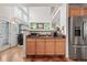 Open-concept kitchen with stainless steel appliances, granite counters, and views of the home's entry at 5146 S Argonne St, Centennial, CO 80015