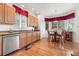 Bright kitchen with light wood cabinets, granite countertops, stainless steel appliances and hardwood floors at 5146 S Argonne St, Centennial, CO 80015