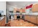 Bright kitchen featuring stainless steel appliances, wood cabinetry, and hardwood floors at 5146 S Argonne St, Centennial, CO 80015