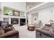 Inviting living room featuring a cozy fireplace, mounted television, and comfortable seating arrangements at 5146 S Argonne St, Centennial, CO 80015
