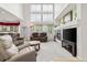 Comfortable living room with a fireplace, large TV, and a high ceiling with a decorative window at 5146 S Argonne St, Centennial, CO 80015