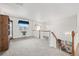 Second story loft area, with carpet, natural lighting, wooden shelving, and white walls at 5146 S Argonne St, Centennial, CO 80015