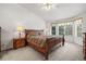 A primary bedroom with a large bed, ceiling fan, and a bay window at 5146 S Argonne St, Centennial, CO 80015