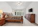 A large primary bedroom features a spacious layout, large bed, bay window, and a wooden dresser at 5146 S Argonne St, Centennial, CO 80015