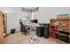 Well-lit home office with a large desk, computer setup, filing cabinets, and organized shelving at 5146 S Argonne St, Centennial, CO 80015