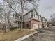 Townhouse style home with attached garage and well-manicured landscaping at 7710 S Monaco Cir # E, Centennial, CO 80112