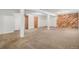 Spacious basement featuring carpeted floors and exposed support beams at 2750 S Rifle St, Aurora, CO 80013