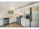 Functional kitchen featuring white cabinets, stainless steel appliances, and durable countertops at 2750 S Rifle St, Aurora, CO 80013