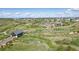 Aerial view of the community showcasing homes, community center, green spaces, and surrounding natural landscape at 2144 Bellcove Dr, Castle Pines, CO 80108