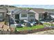 Aerial view of a spacious backyard with a hot tub, patio, outdoor dining area and lush landscaping at 2144 Bellcove Dr, Castle Pines, CO 80108