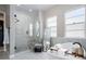 Bright bathroom with a soaking tub, glass shower, and modern finishes at 2144 Bellcove Dr, Castle Pines, CO 80108
