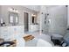 Elegant bathroom boasting a freestanding tub, glass-enclosed shower, and double vanities with modern fixtures at 2144 Bellcove Dr, Castle Pines, CO 80108