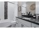Modern bathroom with sleek white cabinets, dark countertops, tiled shower, and stylish decor at 2144 Bellcove Dr, Castle Pines, CO 80108