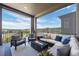 Cozy covered patio with comfortable seating and a fire pit overlooking scenic views at 2144 Bellcove Dr, Castle Pines, CO 80108
