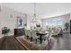Bright dining and living area features hardwood floors, large windows, and comfortable seating at 2144 Bellcove Dr, Castle Pines, CO 80108