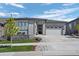 Beautiful single-story home with stone facade, manicured lawn, and attached two-car garage at 2144 Bellcove Dr, Castle Pines, CO 80108