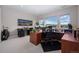 Bright home office with built in desk, large windows, and views of the mountains, perfect for remote work at 2144 Bellcove Dr, Castle Pines, CO 80108